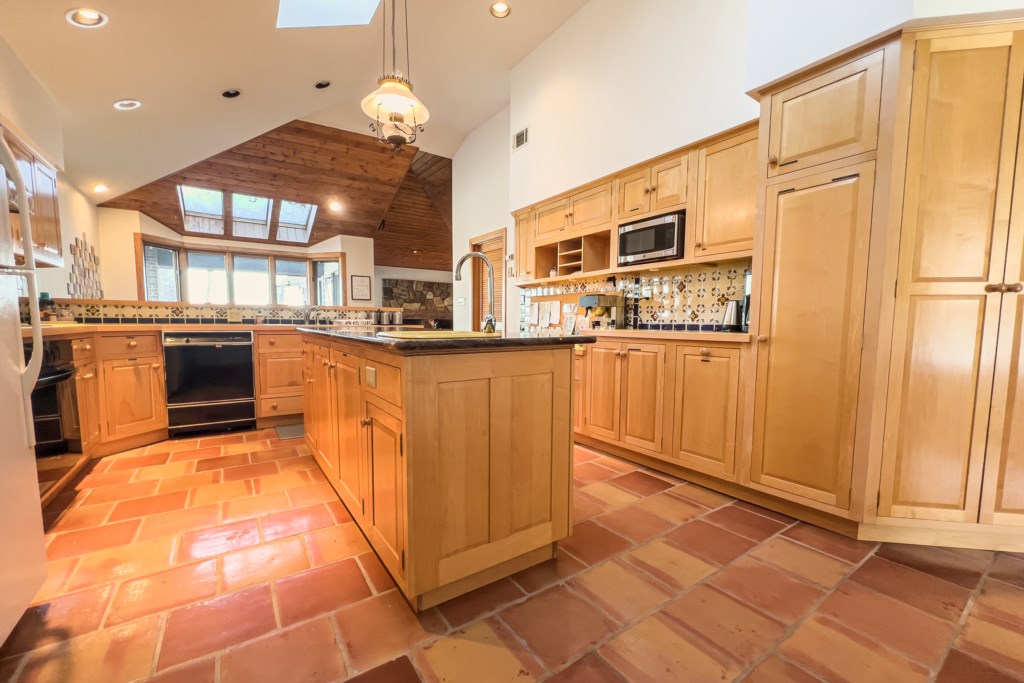 Beautiful Spanish tiled flooring fills up the spacious kitchen area. 