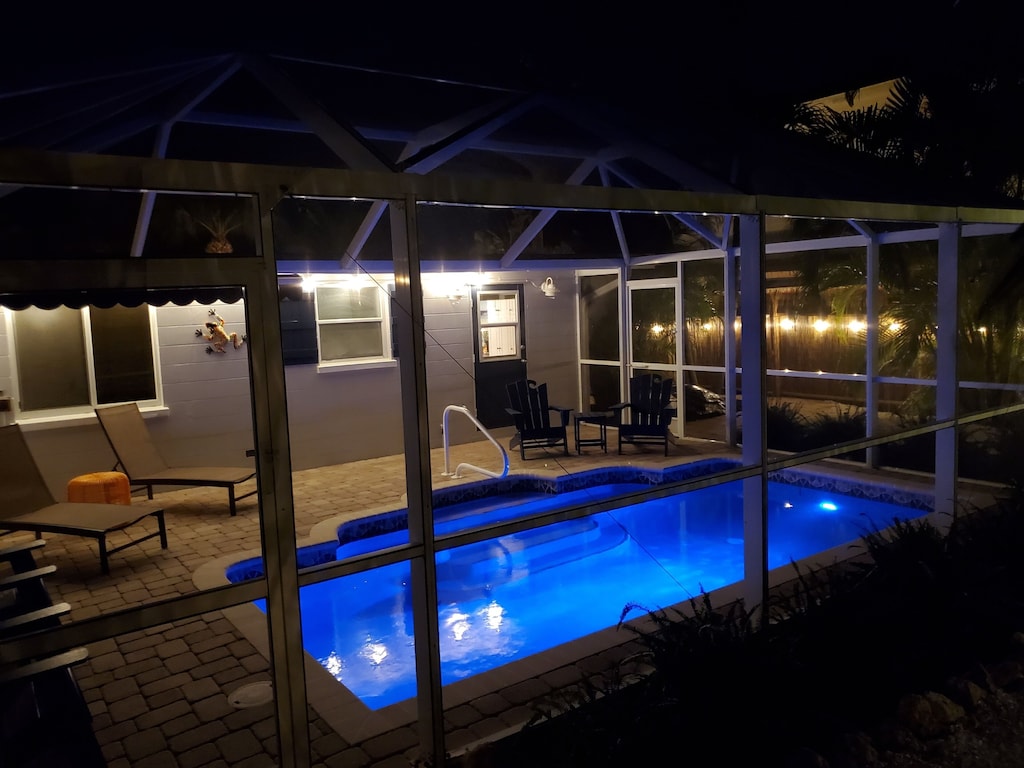 Enjoy a glass of wine by the softly night lighted heated swimming pool.
