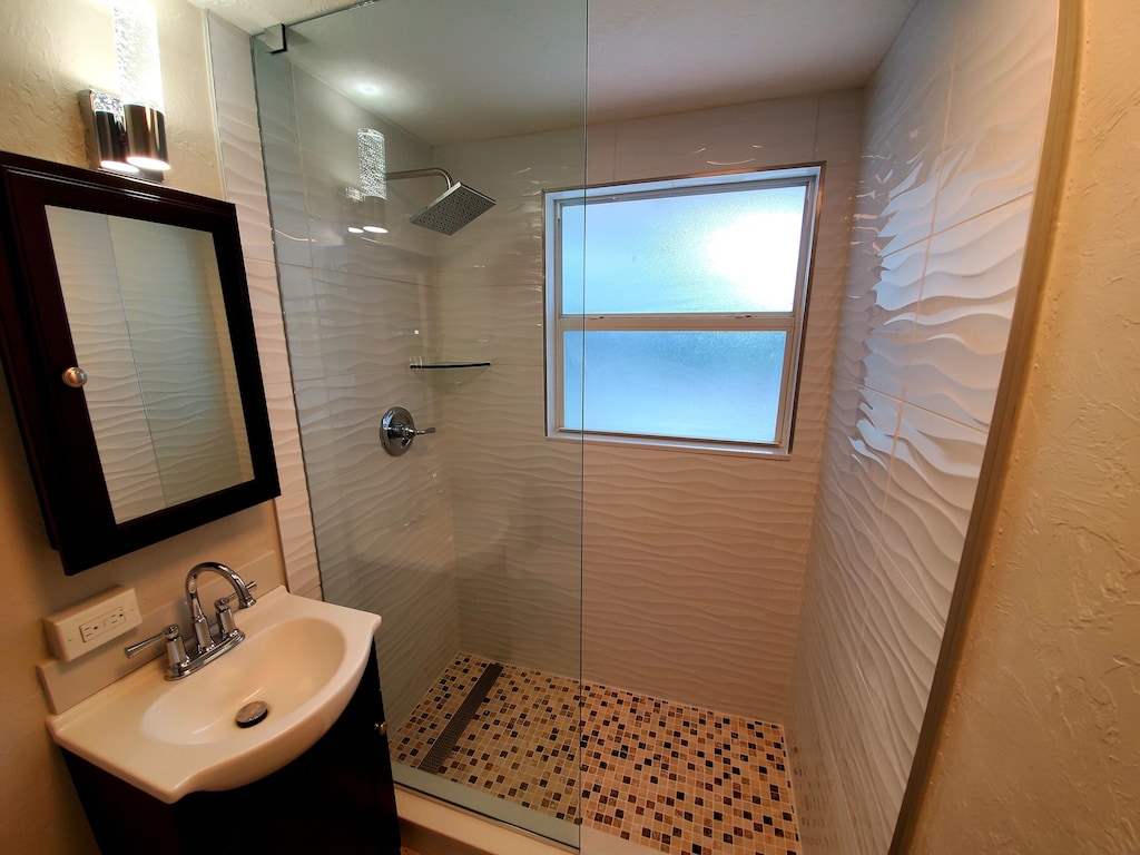 The newly renovated bathroom with wavy tiles is so fitting for a beach vacation.