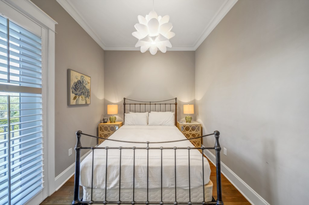 The fifth bedroom offers a queen bed and accommodations for two with an attached bath 