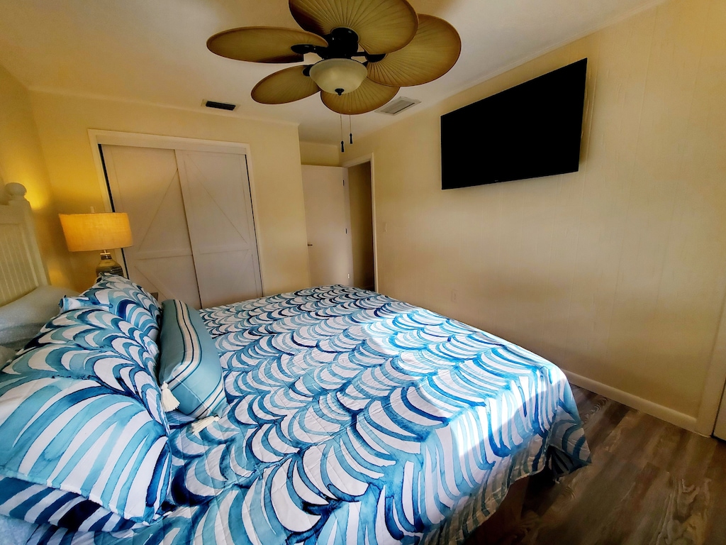 King Master bedroom with flat screen TV, quality linens
