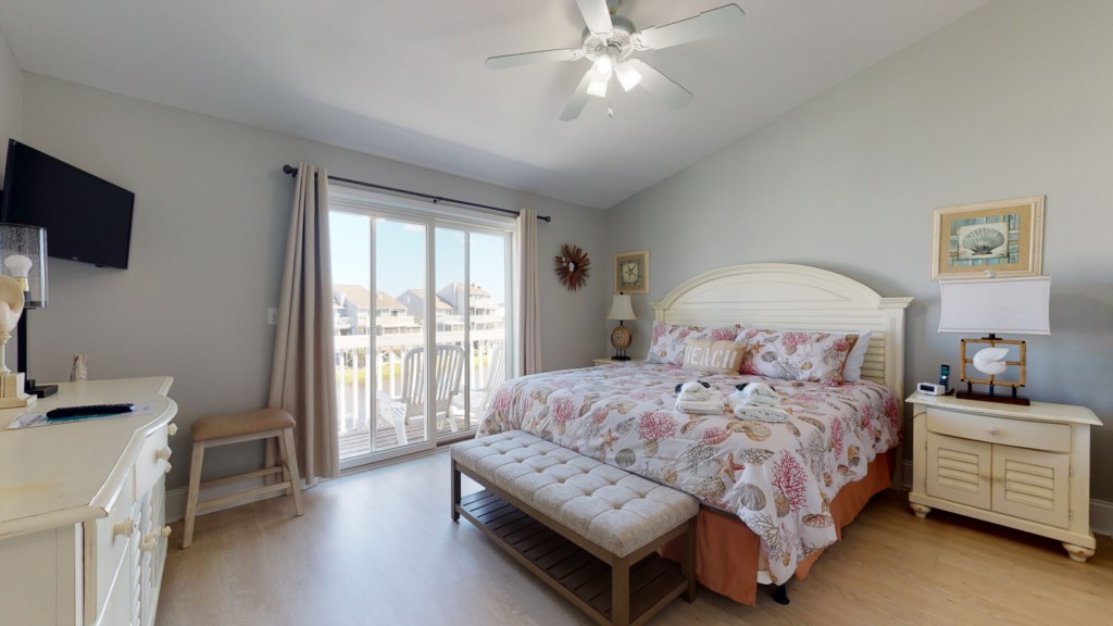 Primary bedroom offers a king bed, private balcony, and attached bathroom 