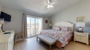 Primary bedroom offers a king bed, private balcony, and attached bathroom 