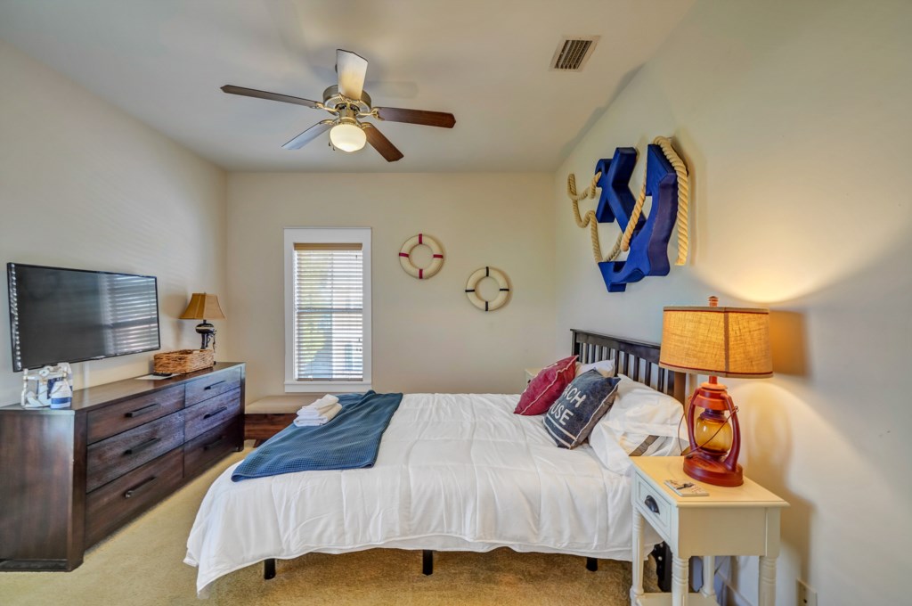 The guest bedroom features a queen bed with ceiling fan, and cable television