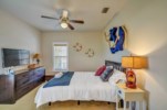 The guest bedroom features a queen bed with ceiling fan, and cable television