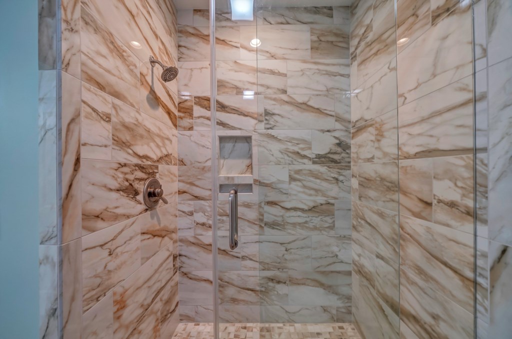 Guest bathroom features a tiled walk-in shower 