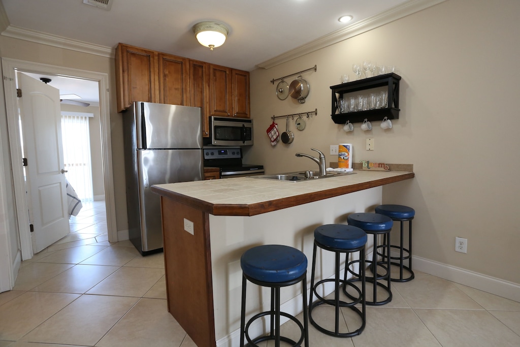 Kitchen and breakfast nook with stainless steel appliances equipped with all of your cooking needs. 