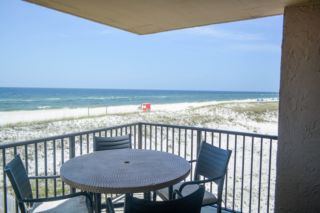 Chill on the balcony with dining for four and expansive beach views!
