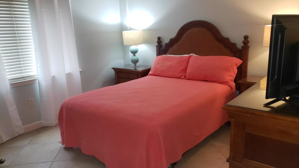 Queen size bed in guest bedroom