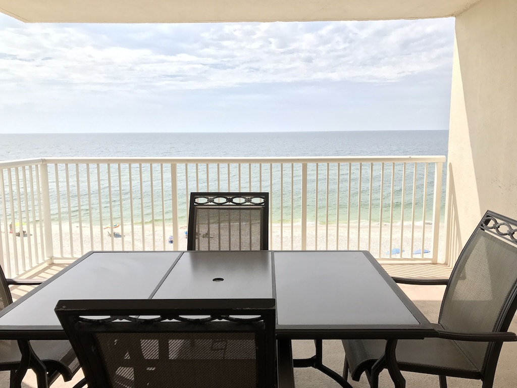 Balcony with patio furniture and a beautiful view of the gulf.