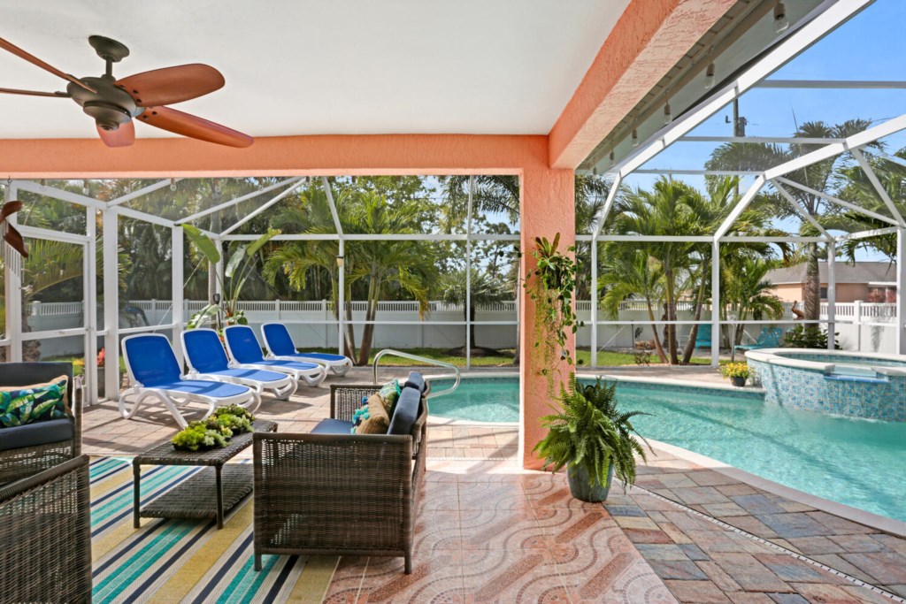 Relax by the private screened pool with comfortable loungers and tropical views.