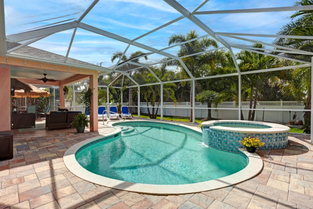 Private screened pool and spa with lush garden views, perfect for relaxation.
