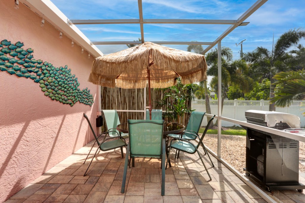 Perfect patio with tiki umbrella and flat top grill