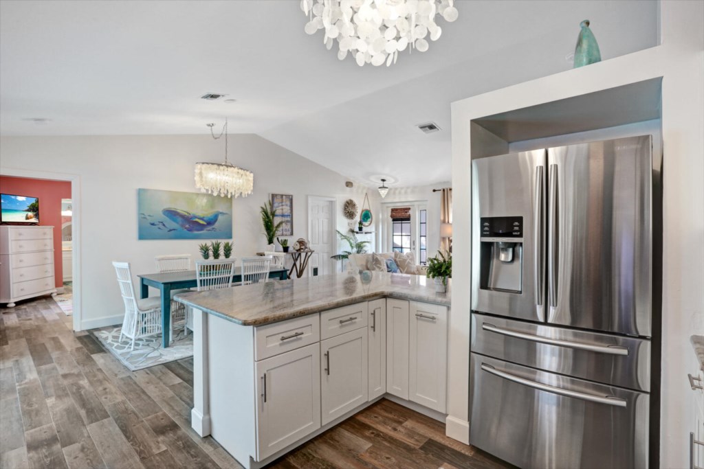 Modern kitchen with stainless steel appliances and open dining area for family gatherings.