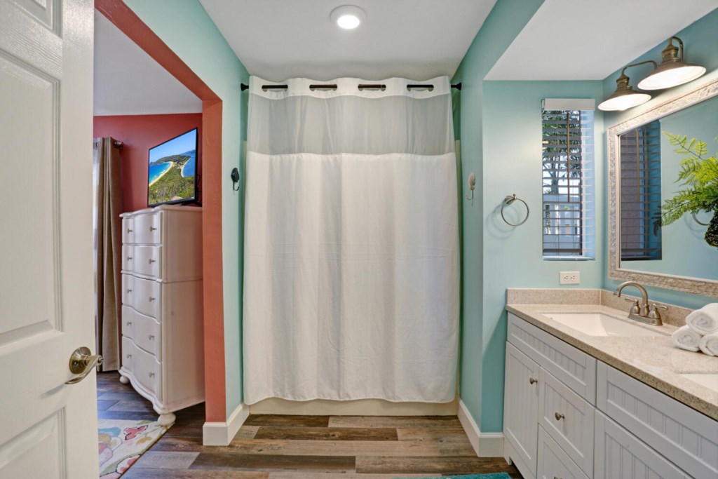 Bright bathroom with modern vanity and walk-in shower for a refreshing start to your day.