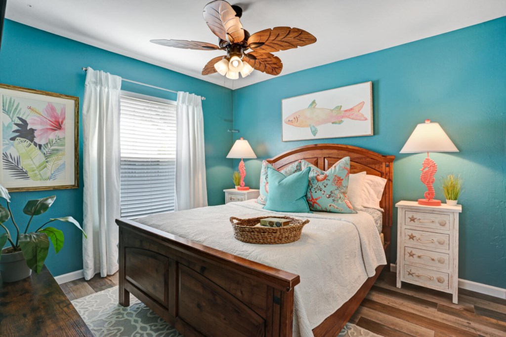 Tropical-themed bedroom with vibrant decor and cozy wooden bed for a relaxing retreat.