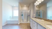 Attached master bath with soaking tub, walk-in shower, and private water closet 