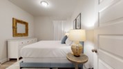 Queen guest bedroom with flat screen television and shared bathroom 