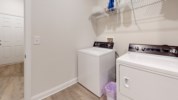 Laundry is provided with additional refrigerator for overflow, and half bathroom