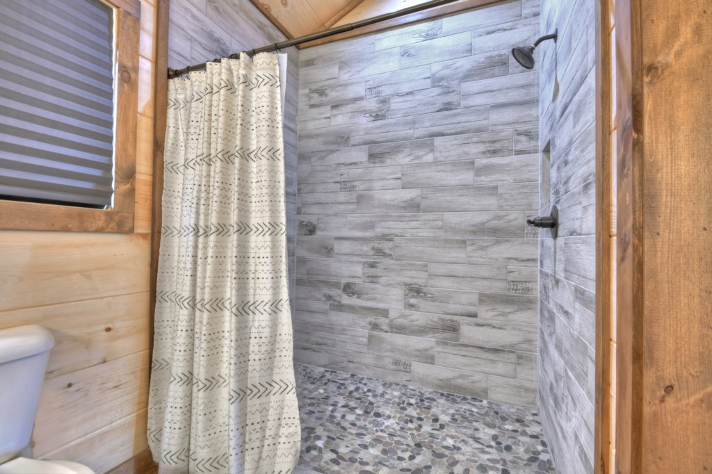 King master bathroom with a beautiful walk in rock shower 