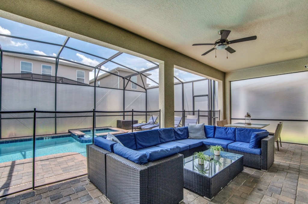 Pool area with great couch, tv, BBQ, table and loungers!