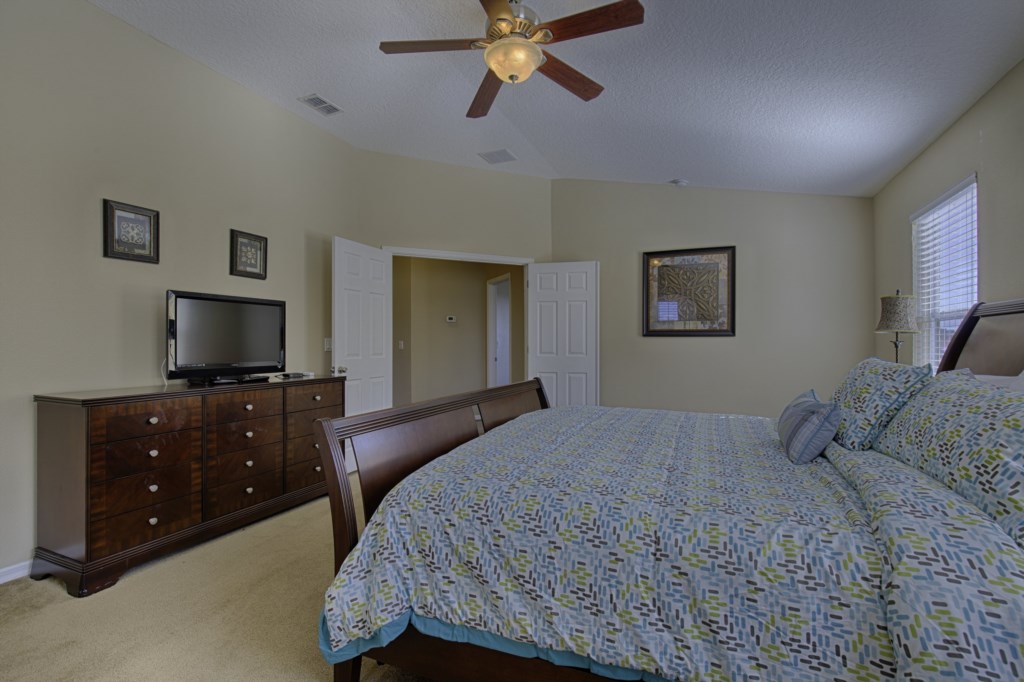 Spacious bedroom with TV and plenty of storage for your clothes.