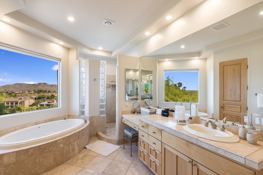 master bedroom bathroom with double sinks,an extra-large bathtub,shower with double shower heads