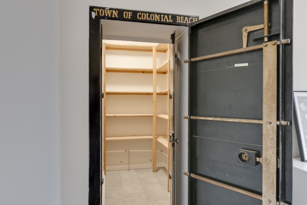 Located on the main floor, this buildings historic safe room has been converted into a walk in closet.