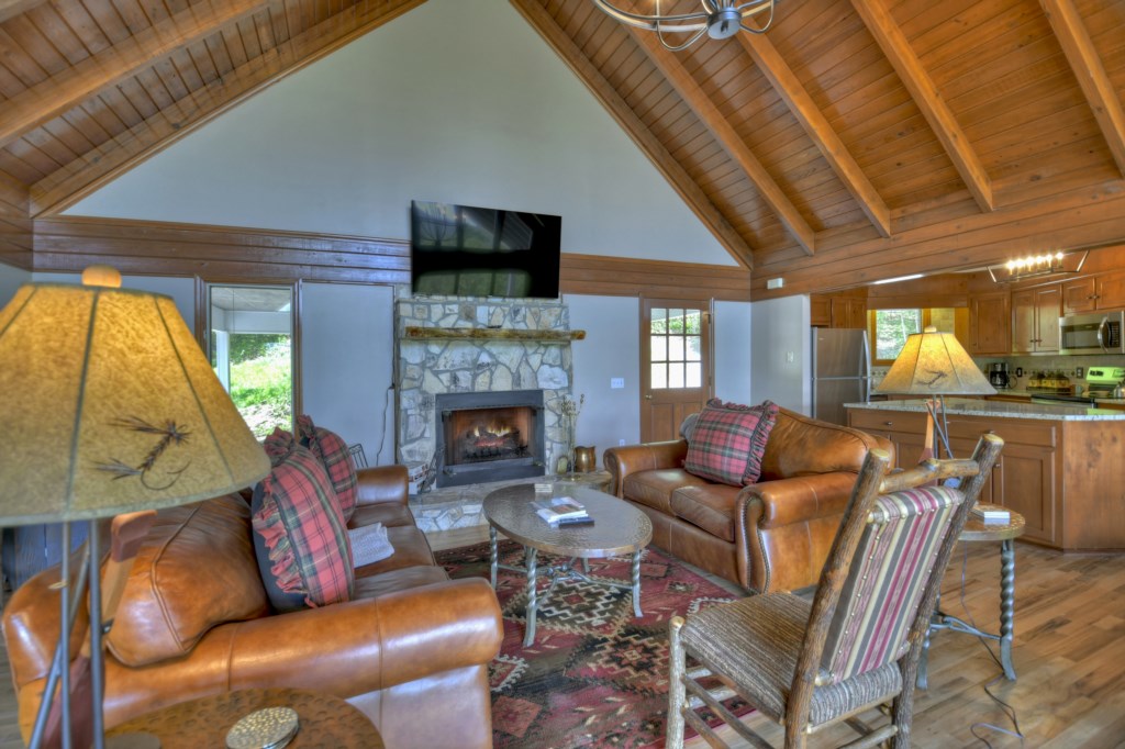 Living area in the main level with a wood burning fireplace 