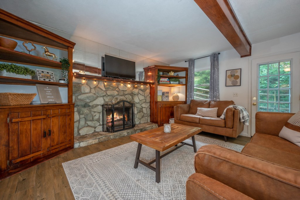 Welcome to Country View Oasis! walk in to a comfortable living room with wood fireplace