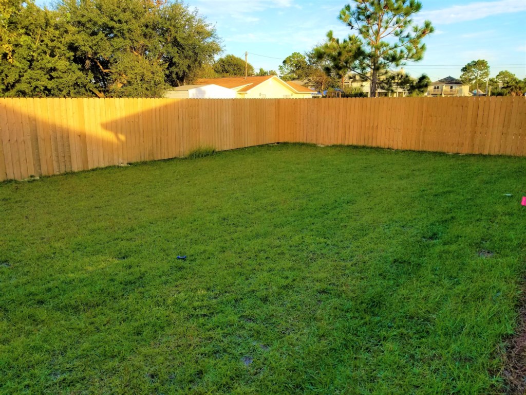 Fenced backyard with propane grill