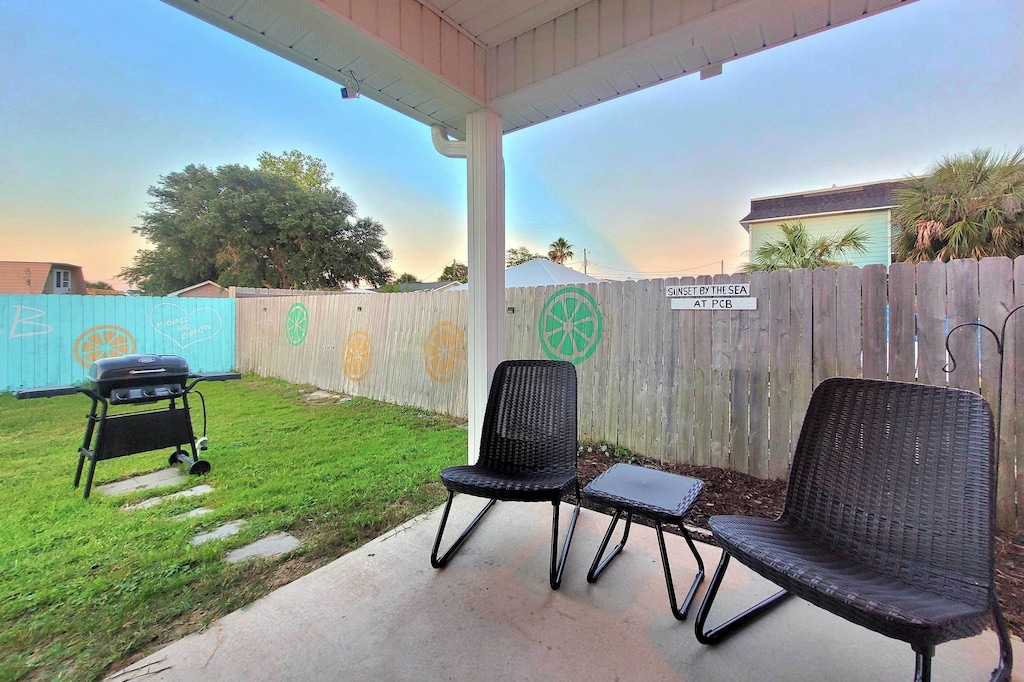 Fenced Yard & Patio with outdoor seating, fan and propane grill