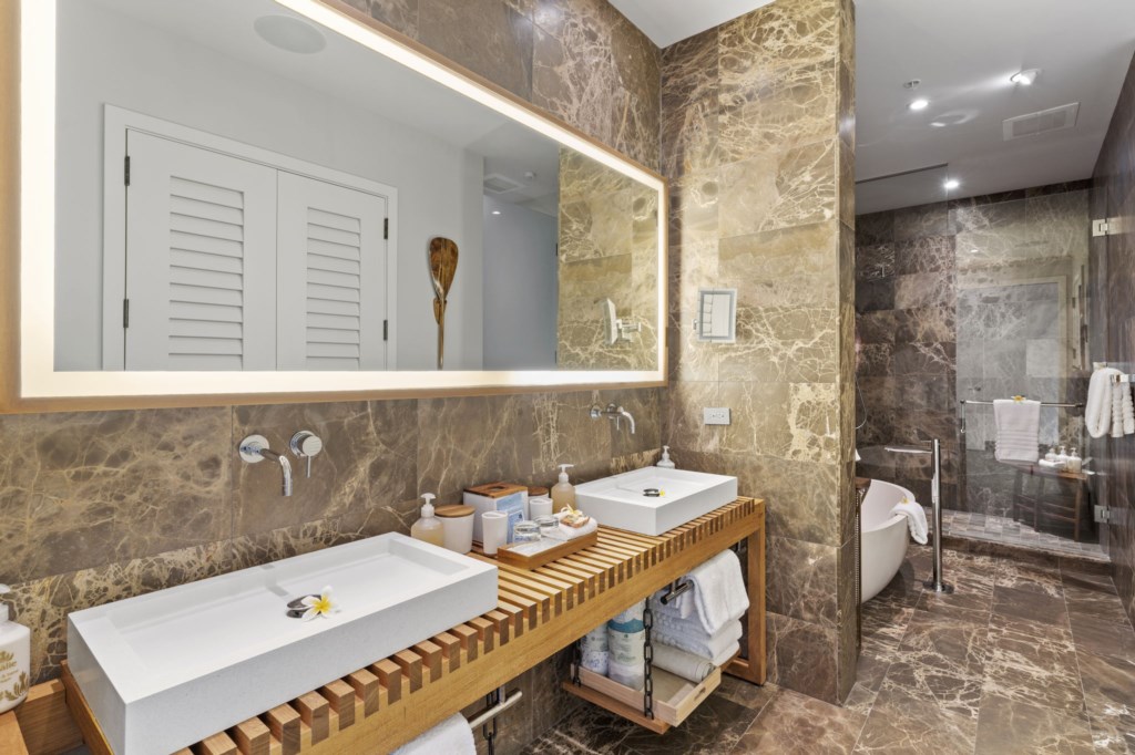 Makai Oceanside bathroom features double sink, huge tub, separate shower area, separate toilet and walking closet