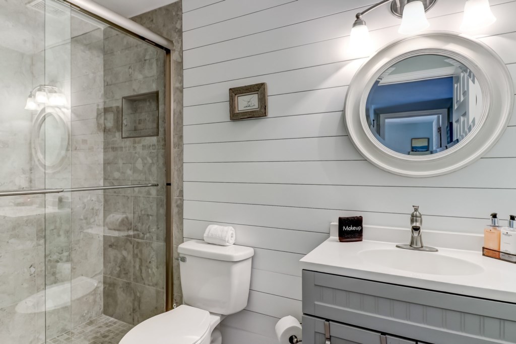 Hall bathroom with shiplap and tiled walk-in shower