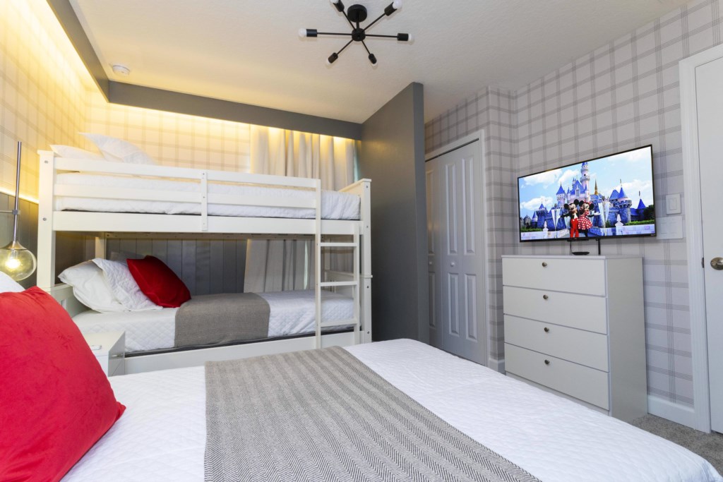 Disney themed bedroom with twin over full bunk bed & TV
