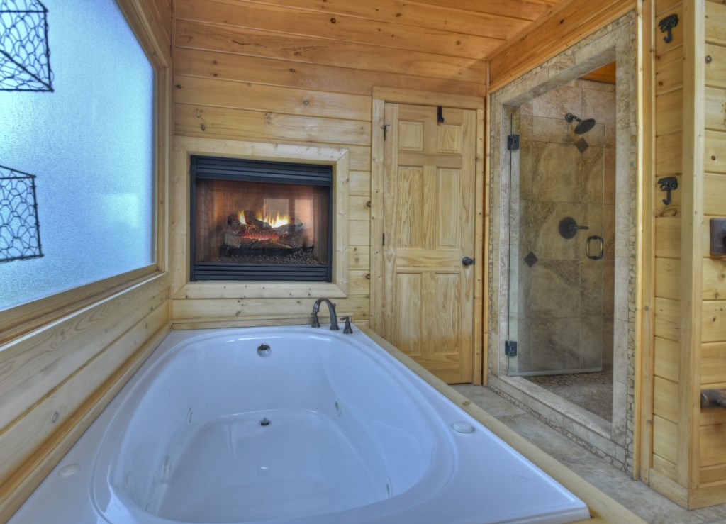 Loft bathroom master bathroom with jetted tub and seasonal gas fireplace 