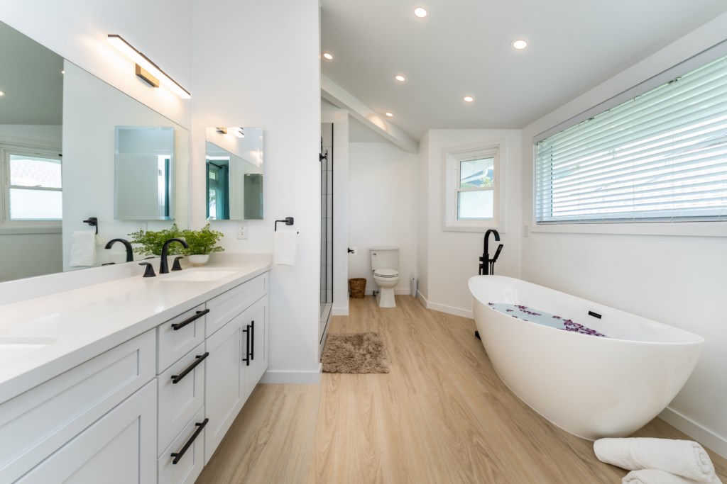 Renovated Primary Bathroom with Dual Vanities, Shower, and Large Soaking Tub 