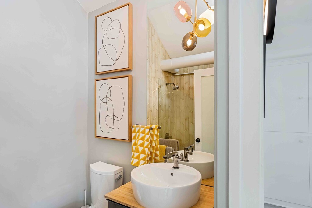 The second bathroom is attractive with a walk-in shower, a large basin sink and modern décor all around