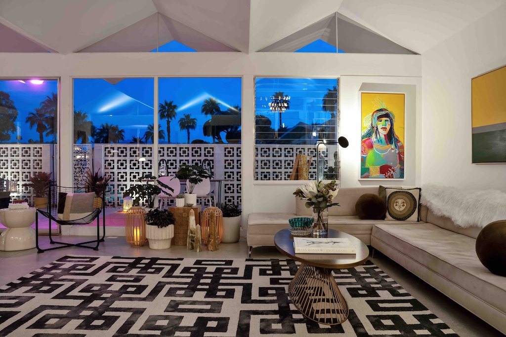 The living room at twilight. Thee angles, the design and the palm trees in the background just set the room.