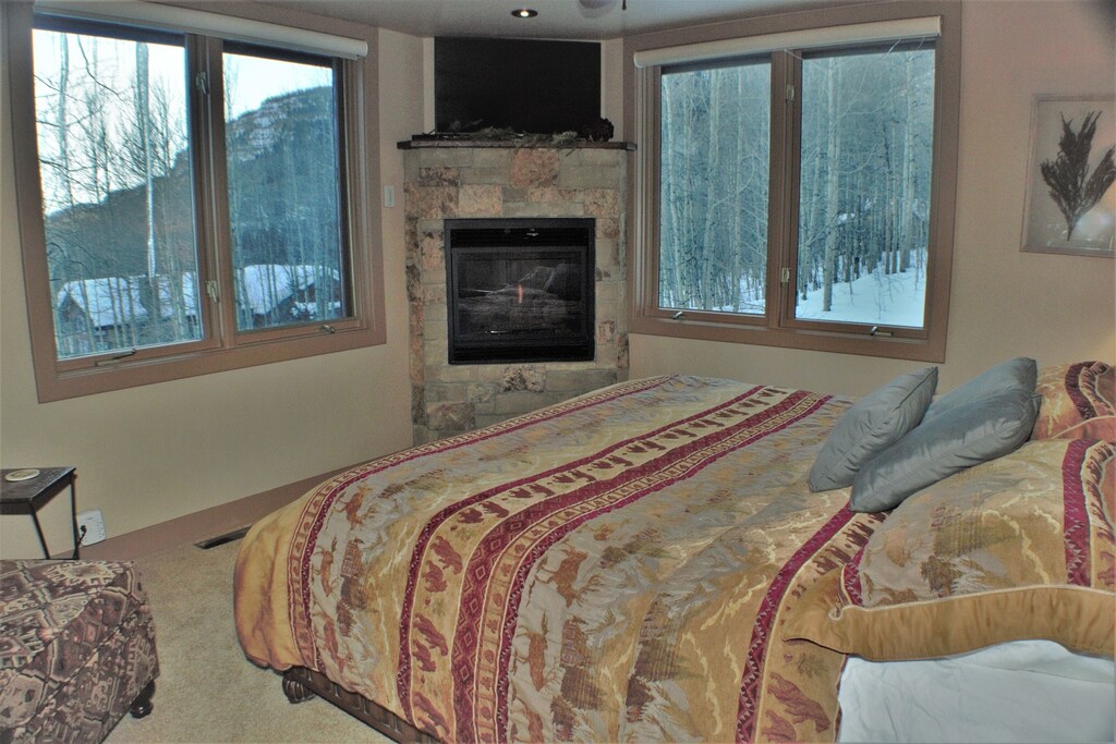 Main Floor Bedroom with King Bed has TV and Gas Fireplace