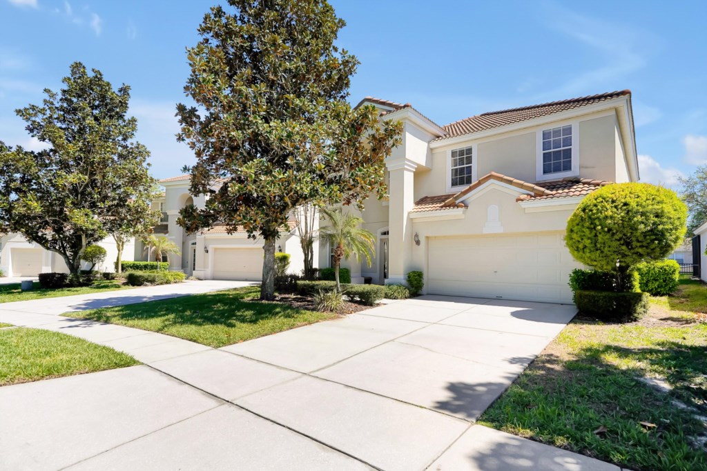 Spacious suburban home with a two-car garage and lush landscaping.