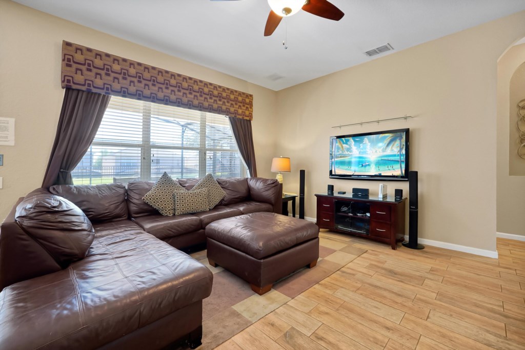 Cozy living room with plush sectional and entertainment system for relaxing evenings.
