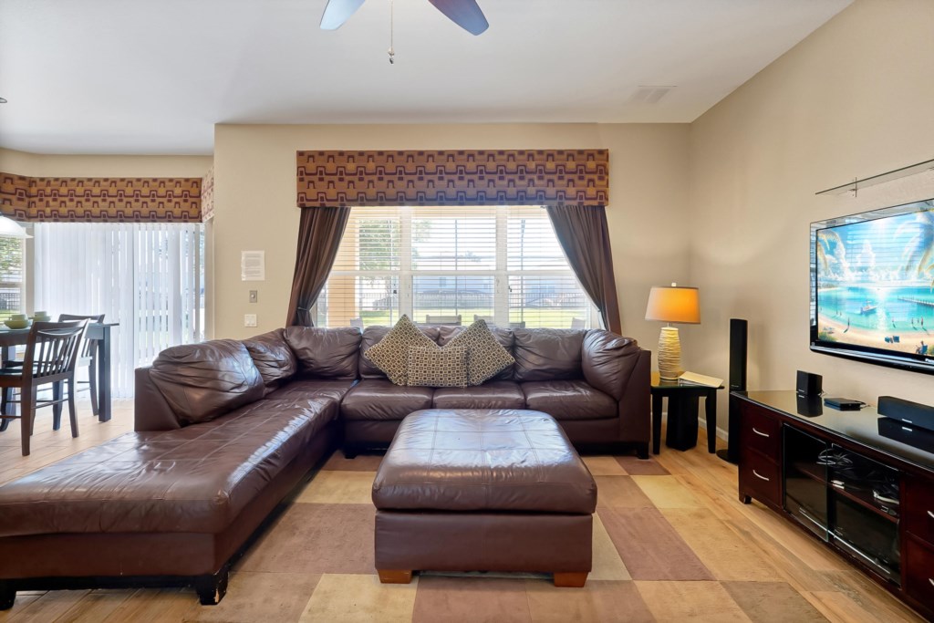 Cozy living room with a large sectional sofa and flat-screen TV for relaxing evenings.