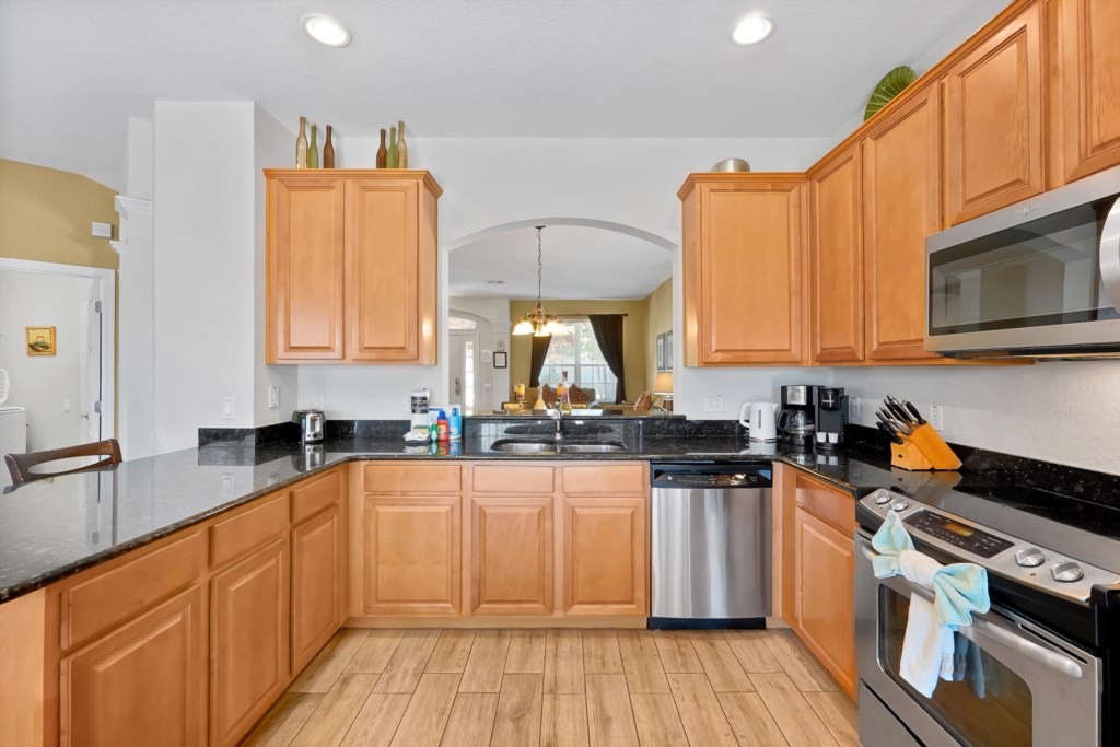 Modern kitchen with granite countertops and stainless steel appliances for gourmet cooking.