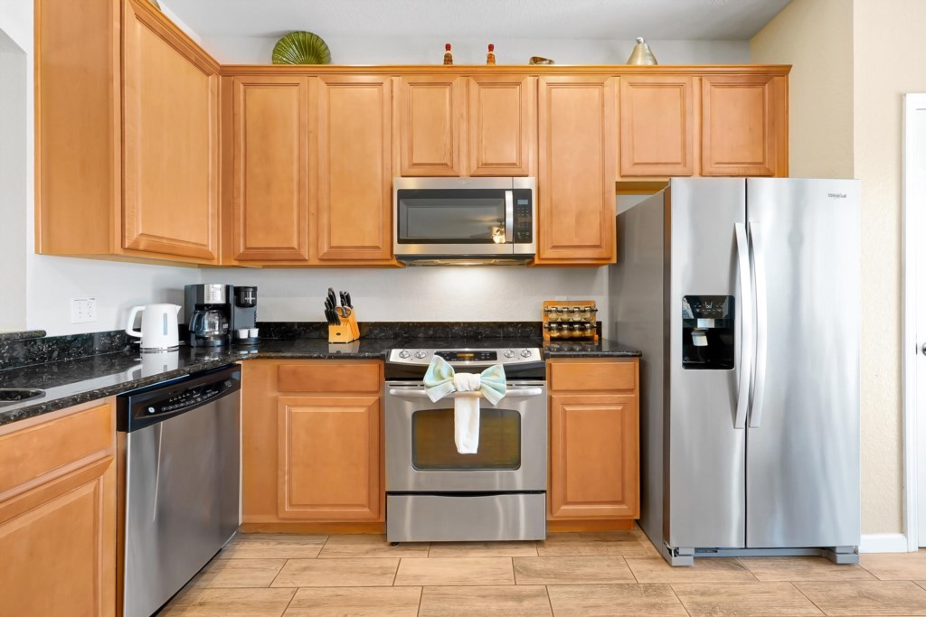 Modern kitchen with granite countertops and stainless steel appliances for gourmet cooking.