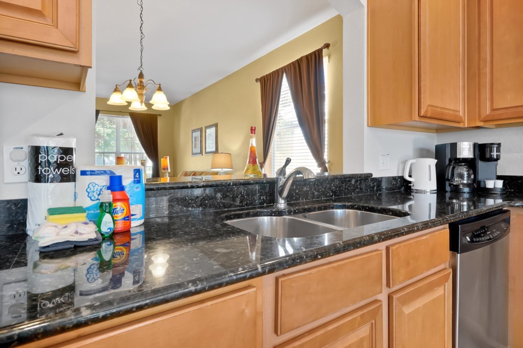 Modern kitchen with granite countertops and stainless steel appliances.