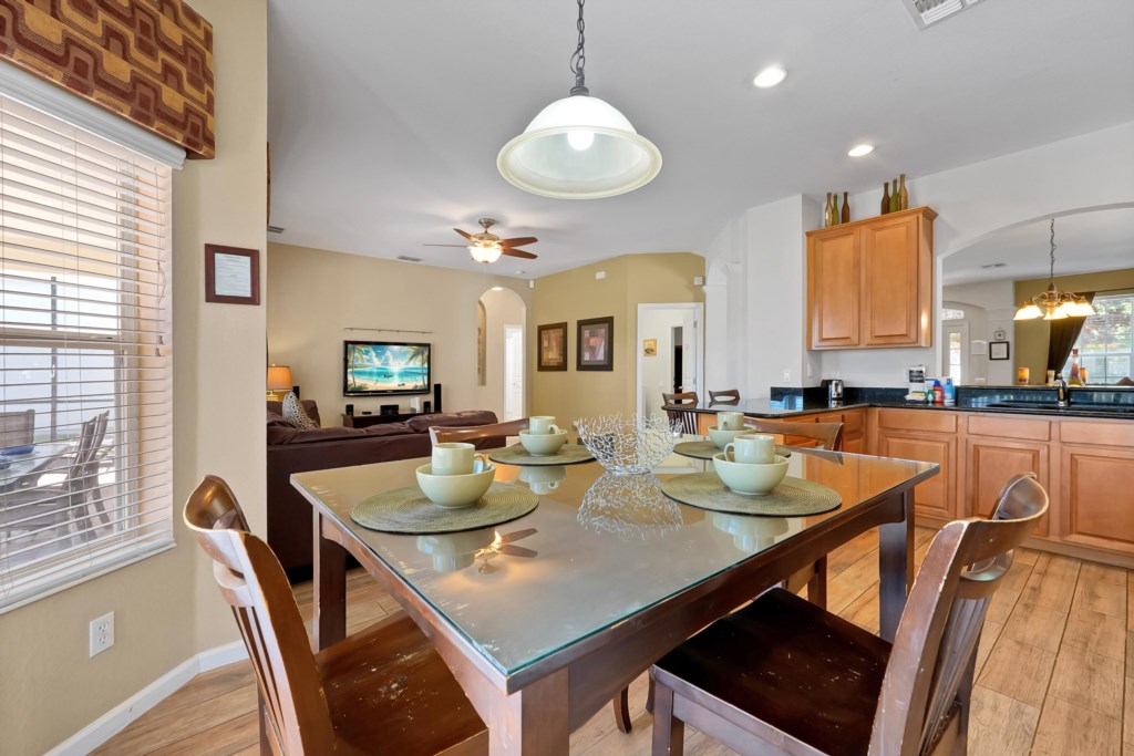 Open-plan kitchen and dining area with modern decor and natural light.