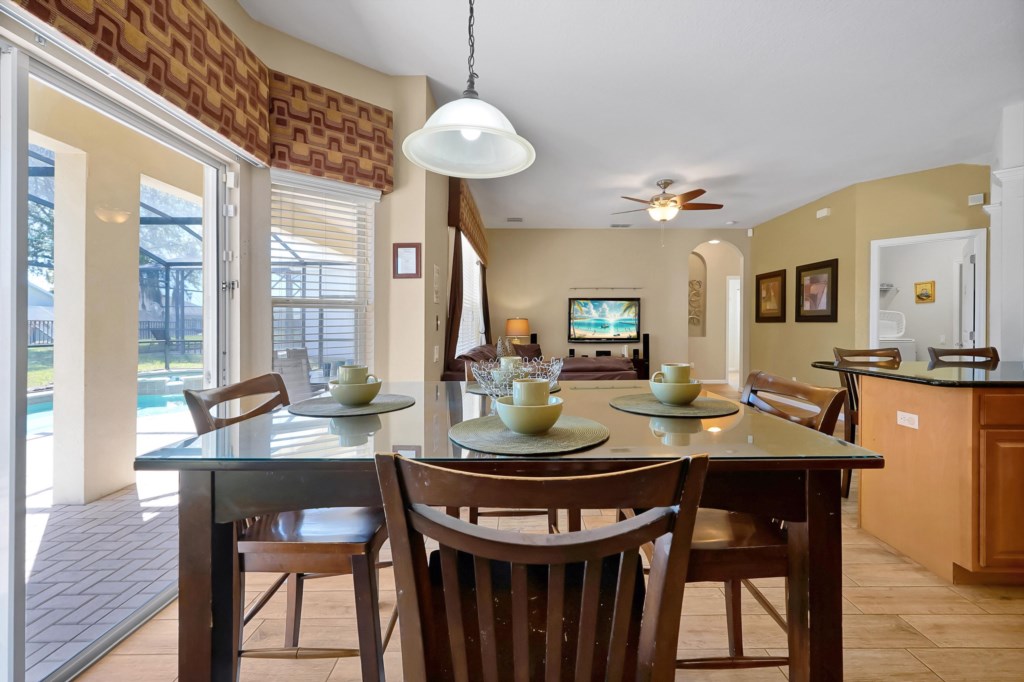Open dining area with pool view, perfect for relaxing meals and family gatherings.