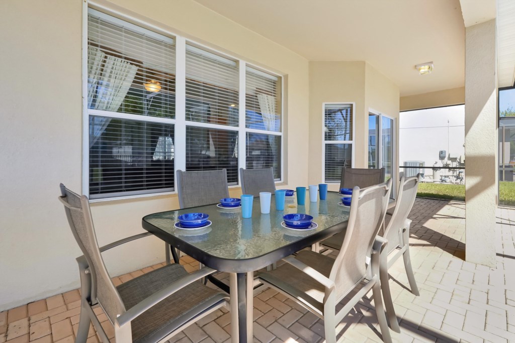 Covered patio dining area perfect for outdoor meals and relaxation.