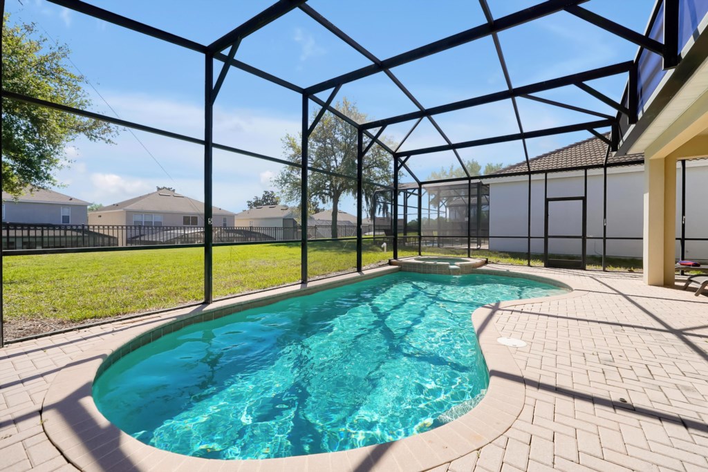 Private screened pool with sunny patio, perfect for relaxation and family fun.